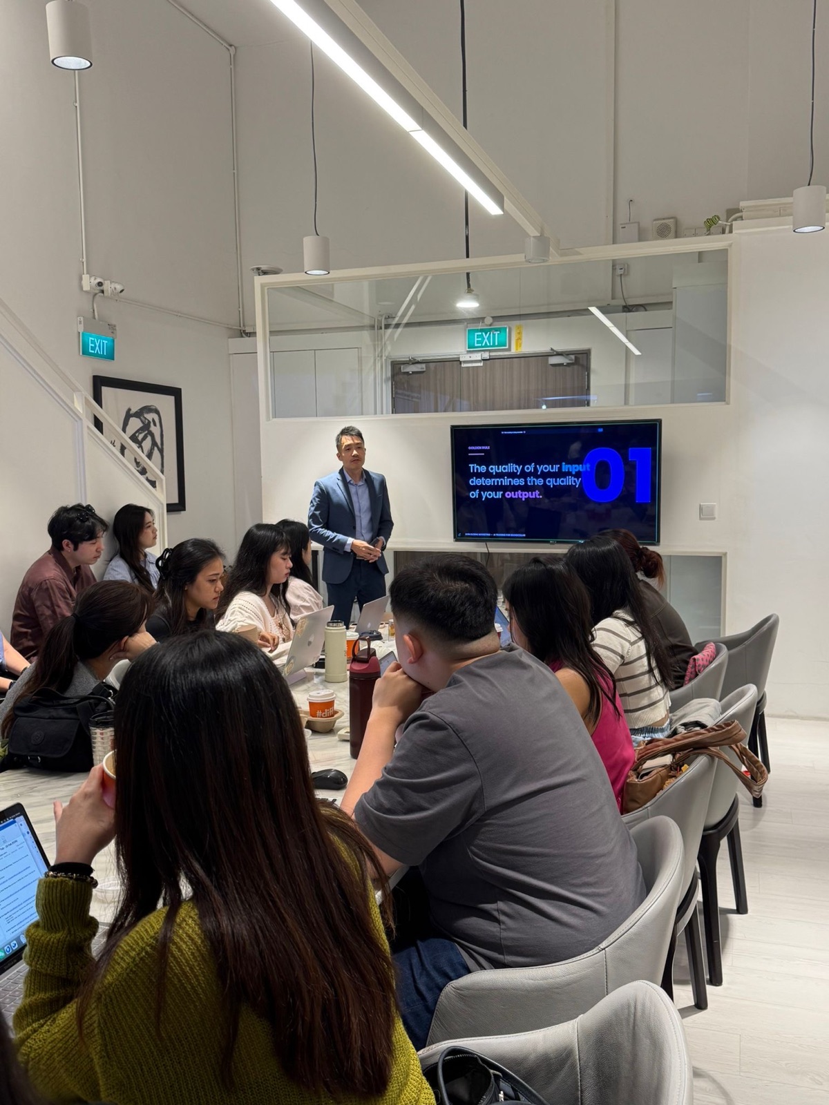 Calvin presenting to the Brand Cellar team in their office, February 2026, with a slide reading: the quality of your input determines the quality of your output